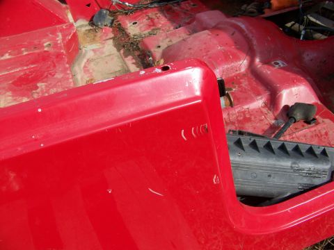 1992 Jeep YJ - The interior of a red vehicle is shown, with the floor pan and side panel visible.