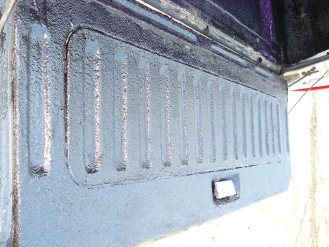 1992 Ford C-350 (Centurion Conversions) - Close-up view of the textured interior of a vehicle's tailgate, showing the latch mechanism.