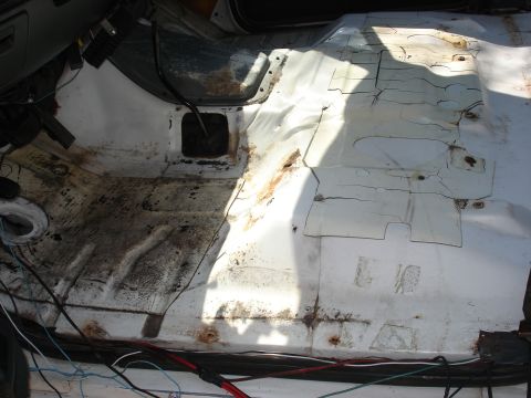 1992 Ford C-350 (Centurion Conversions) - The interior floor shows signs of rust and has exposed wiring, indicating potential repair or modification work.