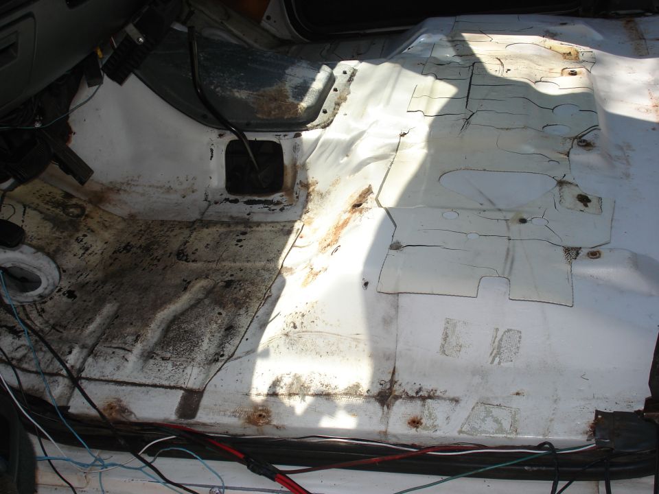 Interior floor with rust and exposed wiring