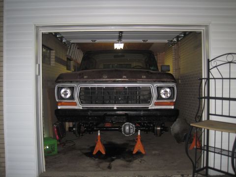 1979 Ford Bronco - Front view of a 1979 Ford Bronco undergoing suspension maintenance in a garage.