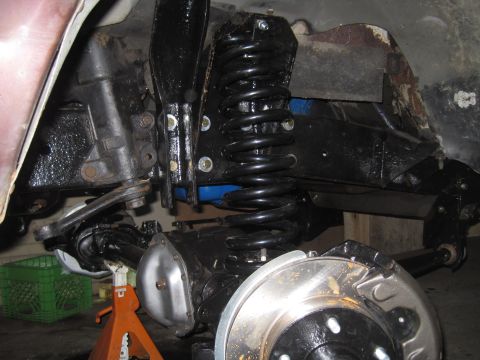 1979 Ford Bronco - This image shows the suspension system of a vehicle, including the coil spring and brake assembly.