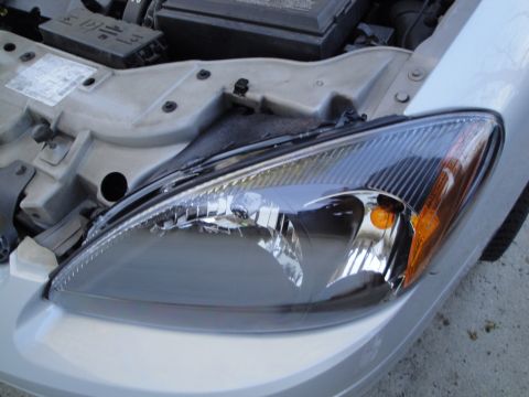 2003 Ford Taurus - The front headlight assembly is visible on a 2003 Ford Taurus.