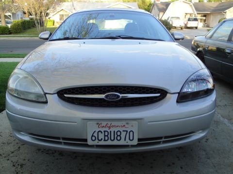 2003 Ford Taurus - Front view of a silver 2003 Ford Taurus, showing its grille and headlights.