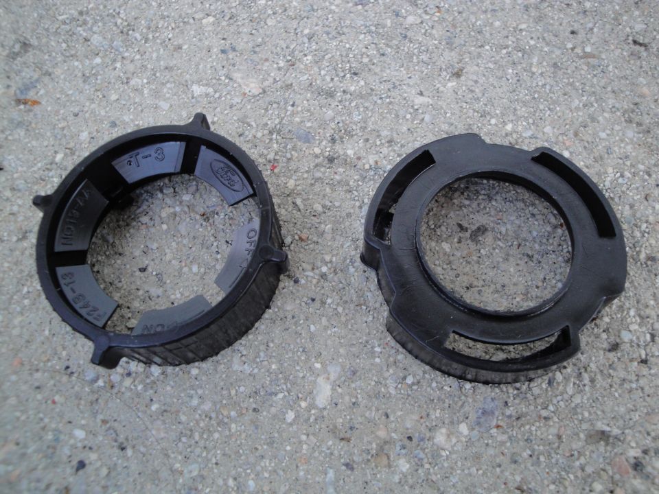 Two black plastic rings, one with Ford logo and part numbers like F243-18