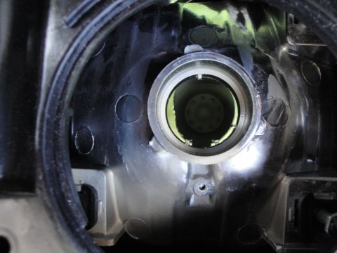 2003 Ford Taurus - Close-up view of the interior of a vehicle's headlight housing, showing the bulb socket.
