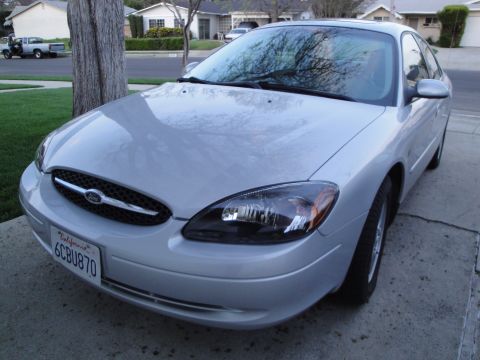 2003 Ford Taurus - This silver 2003 Ford Taurus is shown from the front quarter angle, displaying its headlights and grille.
