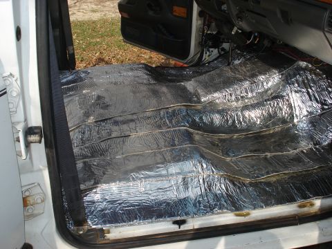1992 Ford C-350 (Centurion Conversions) - Installing sound and heat insulation on the floor of a vehicle's interior.
