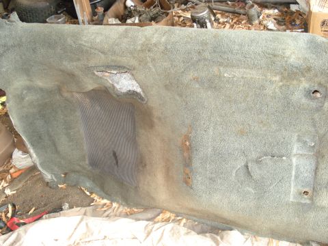 1992 Ford C-350 (Centurion Conversions) - This is a worn carpet piece, possibly from a vehicle's interior, showing damage and rust.