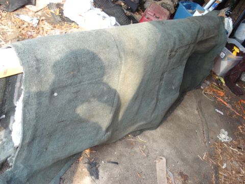1992 Ford C-350 (Centurion Conversions) - A section of automotive carpet is shown, likely removed for repair or replacement.