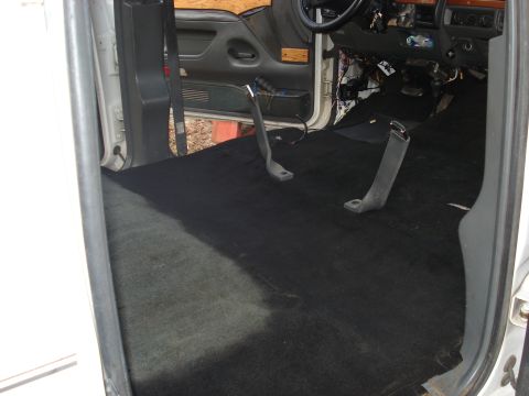 1992 Ford C-350 (Centurion Conversions) - The interior of a van shows exposed wiring and black carpet, suggesting ongoing work or repair.