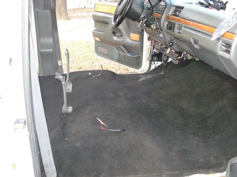 1992 Ford C-350 (Centurion Conversions) - The interior of a truck shows a bare floor with exposed wiring and the dashboard visible.