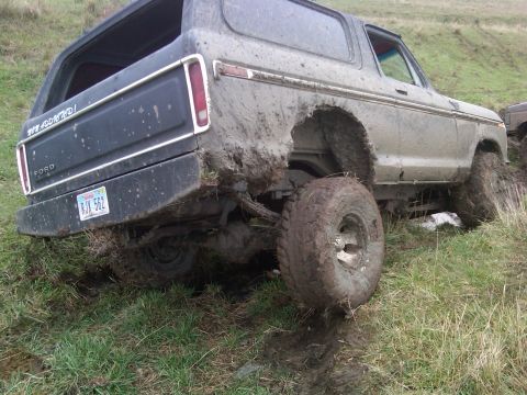 1978 Ford Bronco - This 1978 Ford Bronco is stuck deep in the mud on a grassy slope.