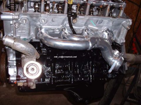 2000 Ford Crown Victoria - Left head on the freshly painted block. New shorty headers.