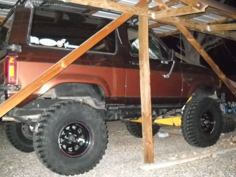 1986 Ford Bronco II - This 1986 Ford Bronco II is shown from the side, parked under a rustic shelter.
