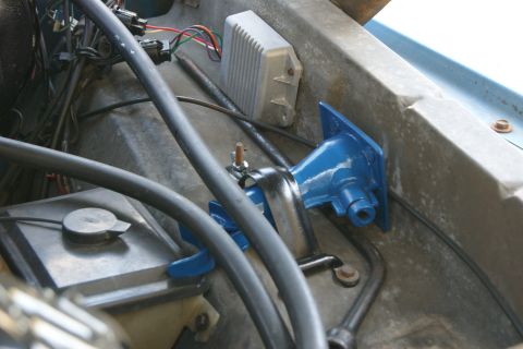 1978 Ford Bronco - Close-up view of engine bay components, including a blue bracket and a grey electrical module.