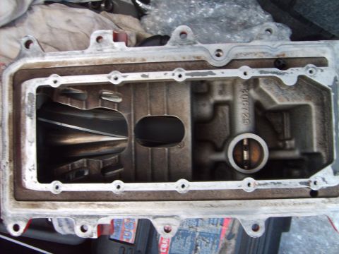 1993 Ford Crown Victoria - Close-up of a disassembled supercharger component, showing the intricate rotor mechanism within the housing.