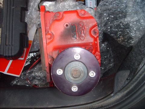 1993 Ford Crown Victoria - Red Ford transmission housing with a purple flange bolted to it, possibly for a car or truck.