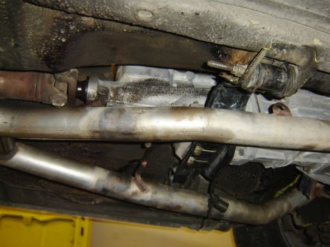 1979 Ford Mustang - The underside of a vehicle shows the exhaust system and transmission components.