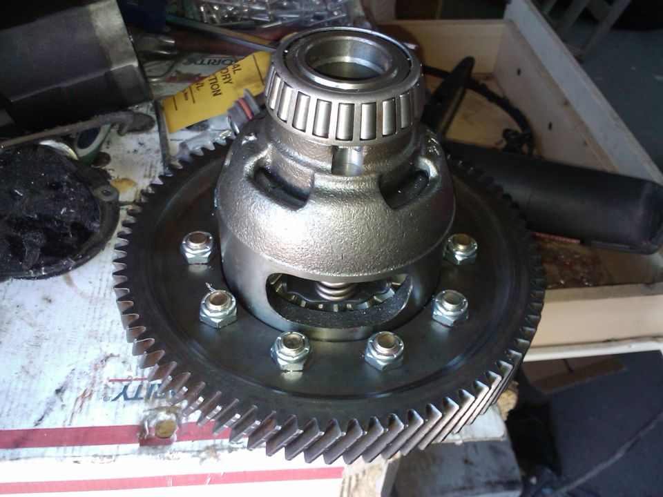 Differential gear assembly with bearing and bolts on a workbench