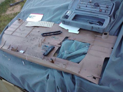 1995 Ford Probe - A disassembled car dashboard panel lies on a tarp with various tools and mail scattered across it.