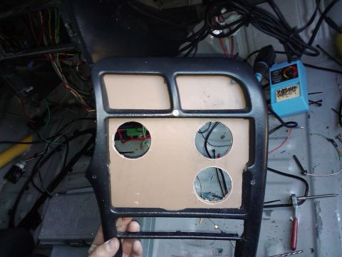 1995 Ford Probe - Dashboard trim piece with wiring visible through cutouts, part of a car interior.