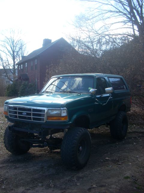 1996 Ford Bronco - This lifted 1996 Ford Bronco is shown in a three-quarter front view, parked outdoors.