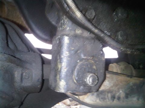 1986 Ford Bronco - Underside view of a vehicle's suspension part, heavily greased.