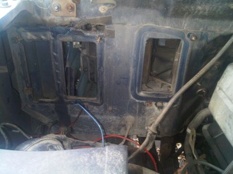 1986 Ford Bronco - View of the HVAC system ductwork inside a vehicle, showing exposed wiring and openings.