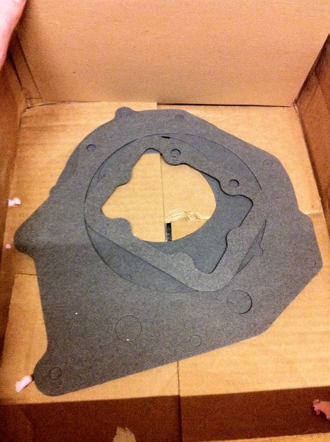 1989 Ford Bronco - Several transfer case gaskets are stacked inside a cardboard box, ready for installation.