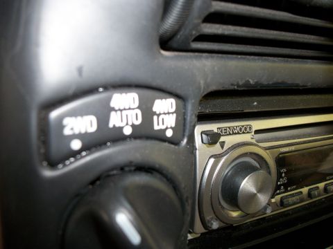 1994 Ford Explorer - Close-up of a vehicle's interior dashboard controls, showing a 4WD selector and a Kenwood car stereo.