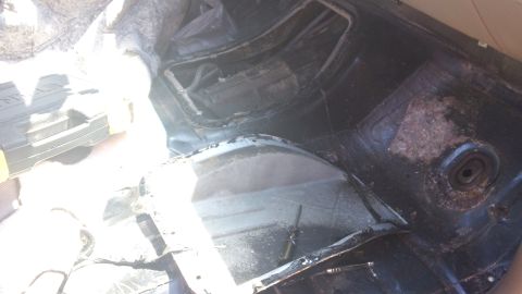 1994 Ford Bronco - The interior of a vehicle shows signs of wear and tear, with exposed metal and damaged upholstery.