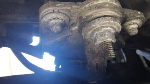 1994 Ford Bronco - A close-up view of a vehicle's suspension ball joint, showing signs of wear and corrosion.
