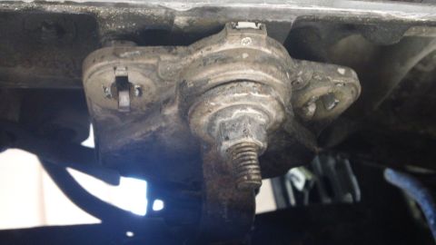 1994 Ford Bronco - Close-up view of a vehicle's ball joint assembly, showing a threaded bolt and metal components.