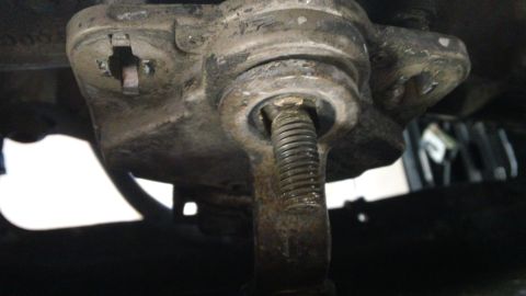 1994 Ford Bronco - A close-up view of a vehicle's suspension ball joint, showing wear and rust.