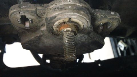 1994 Ford Bronco - A close-up view of a vehicle's suspension component, a prominent bolt and the Supermotors.net logo at the bottom.