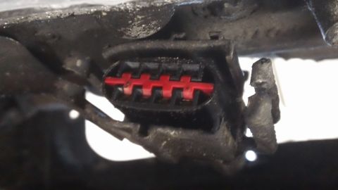 1994 Ford Bronco - A close-up view of a vehicle's electrical connector with visible red pins.