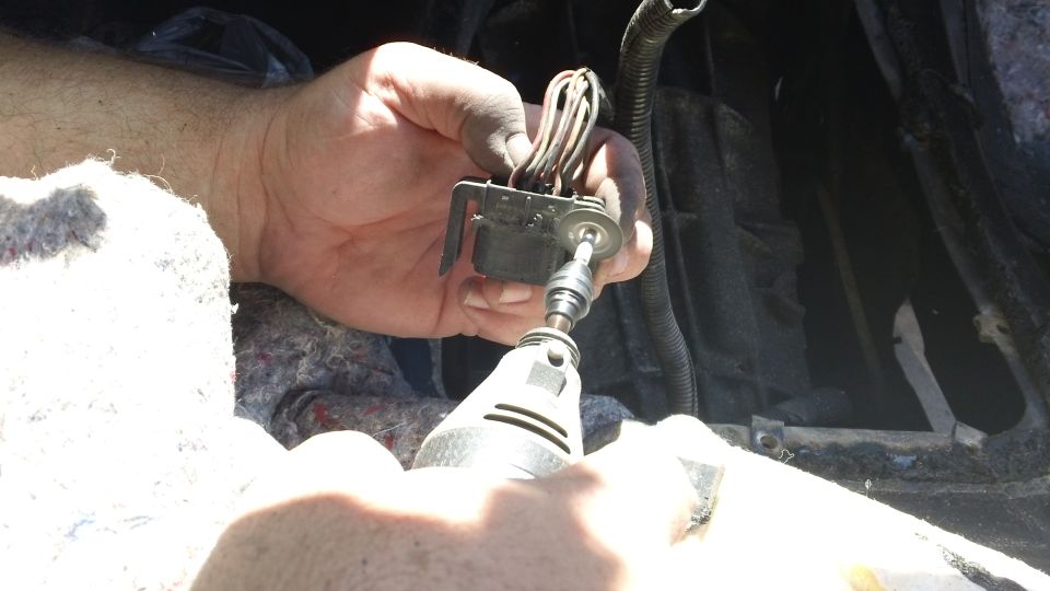 Hand holding wiring harness connector while using a rotary tool with a cutting disc