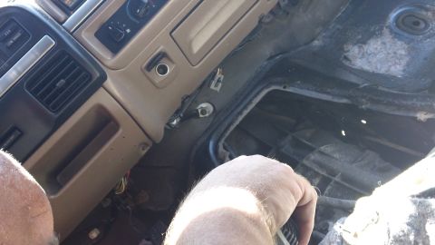 1994 Ford Bronco - The interior of a tan and black 1992 Ford Bronco shows exposed wiring and a disassembled center console.