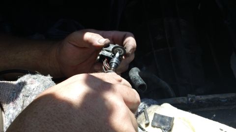 1994 Ford Bronco - Close-up of hands manipulating an electrical connector and wires.