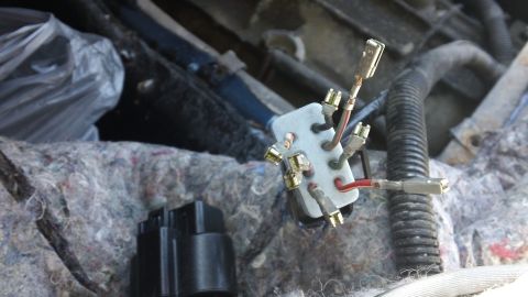 1994 Ford Bronco - Close-up of a vehicle's electrical wiring harness connector and terminal block.