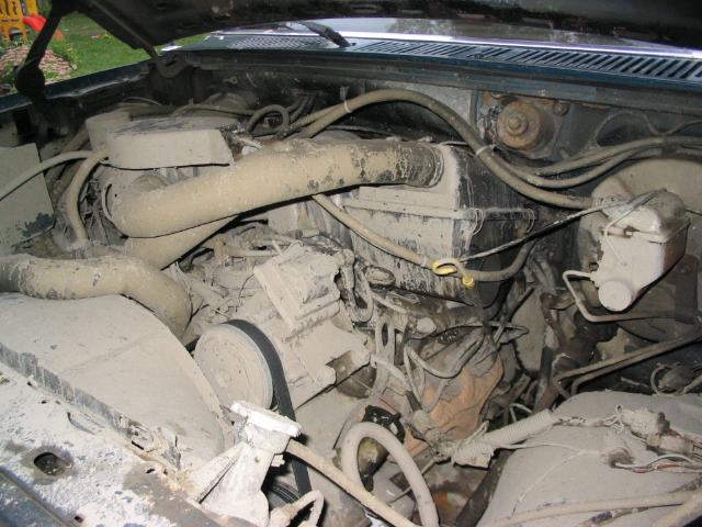 Engine bay with dusty components and hoses