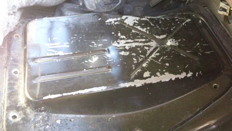 1994 Ford Bronco - The interior floor pan shows signs of wear and tear with chipped paint revealing a lighter color underneath.