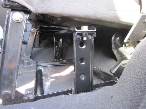 2008 Jeep Wrangler - Underside view of a seat mounting bracket, showing its construction and attachment points.