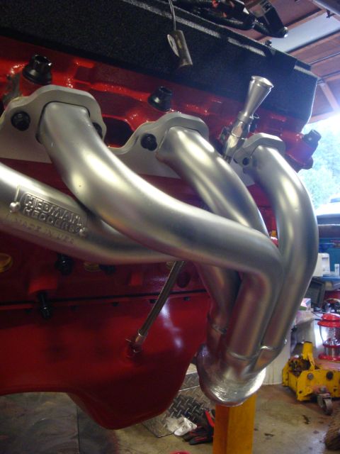 1989 Ford Bronco - Engine block and exhaust headers are shown in detail, with visible text on the headers indicating the manufacturer.