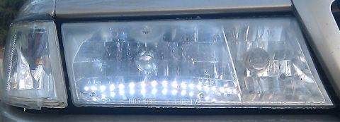 2000 Mercury Grand Marquis - A close-up view of a car's headlight assembly, an aftermarket LED strip.