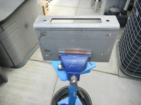 1997 Ford Ranger - A metal bracket is secured in a vise, ready for modification or repair.