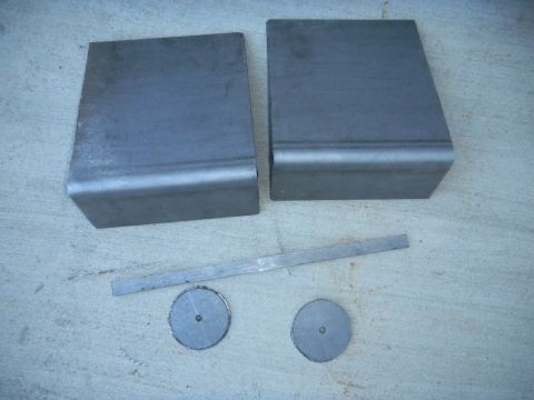 1997 Ford Ranger - Unidentified metal parts, possibly for a vehicle rebuild, are laid out on a concrete surface.