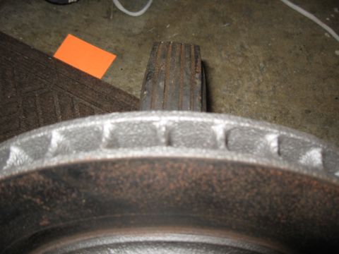 1968 Shelby GT500 - Close-up of a vented car brake rotor, showing surface rust.