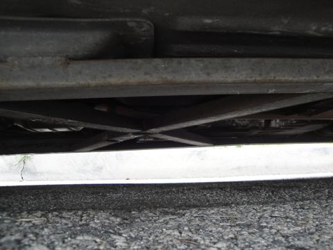 2003 Ford Taurus - The undercarriage of a vehicle is visible, showing metal supports and components.